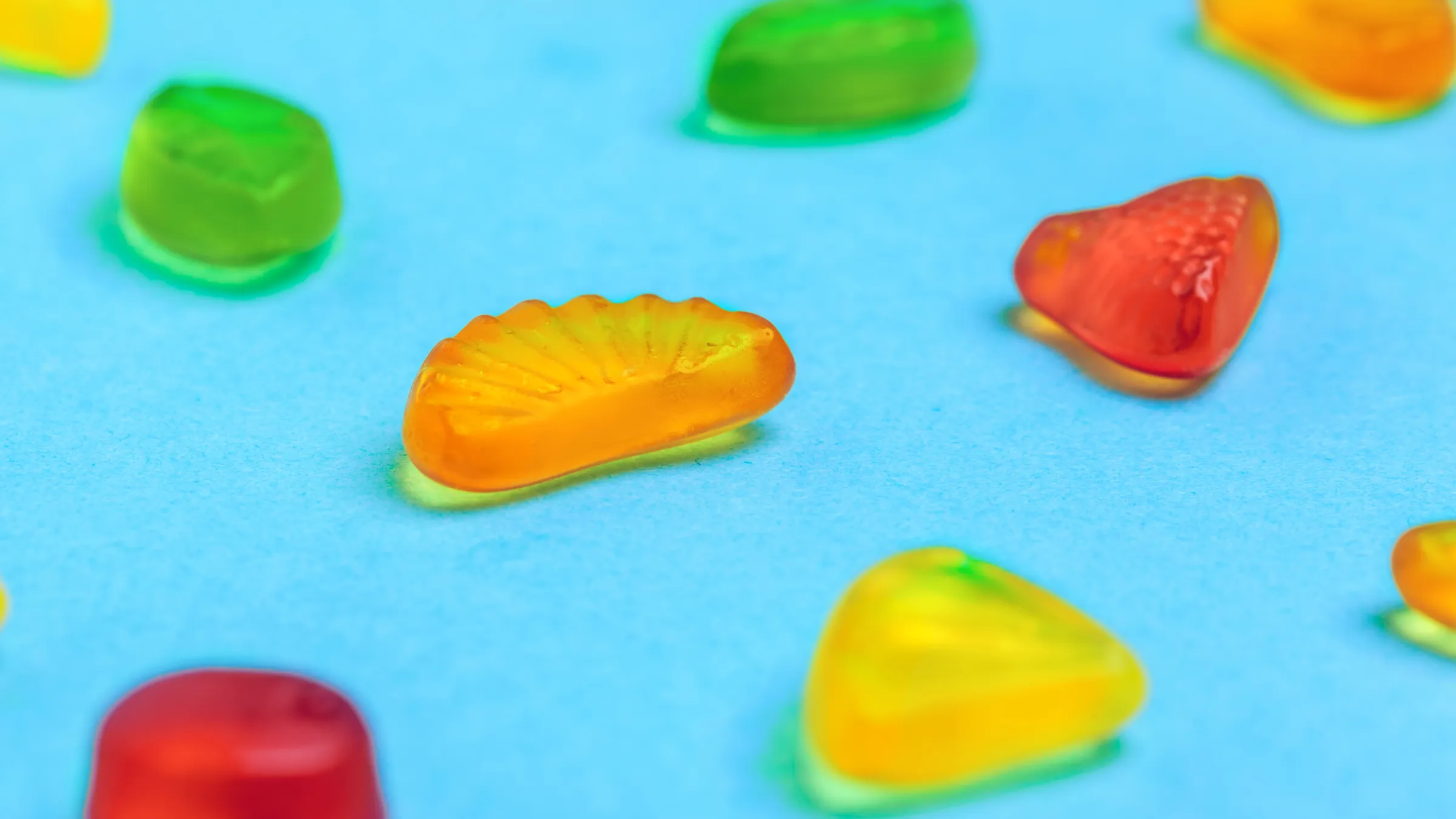 2.Assorted fruit shaped halal kosher gummy candies on blue background