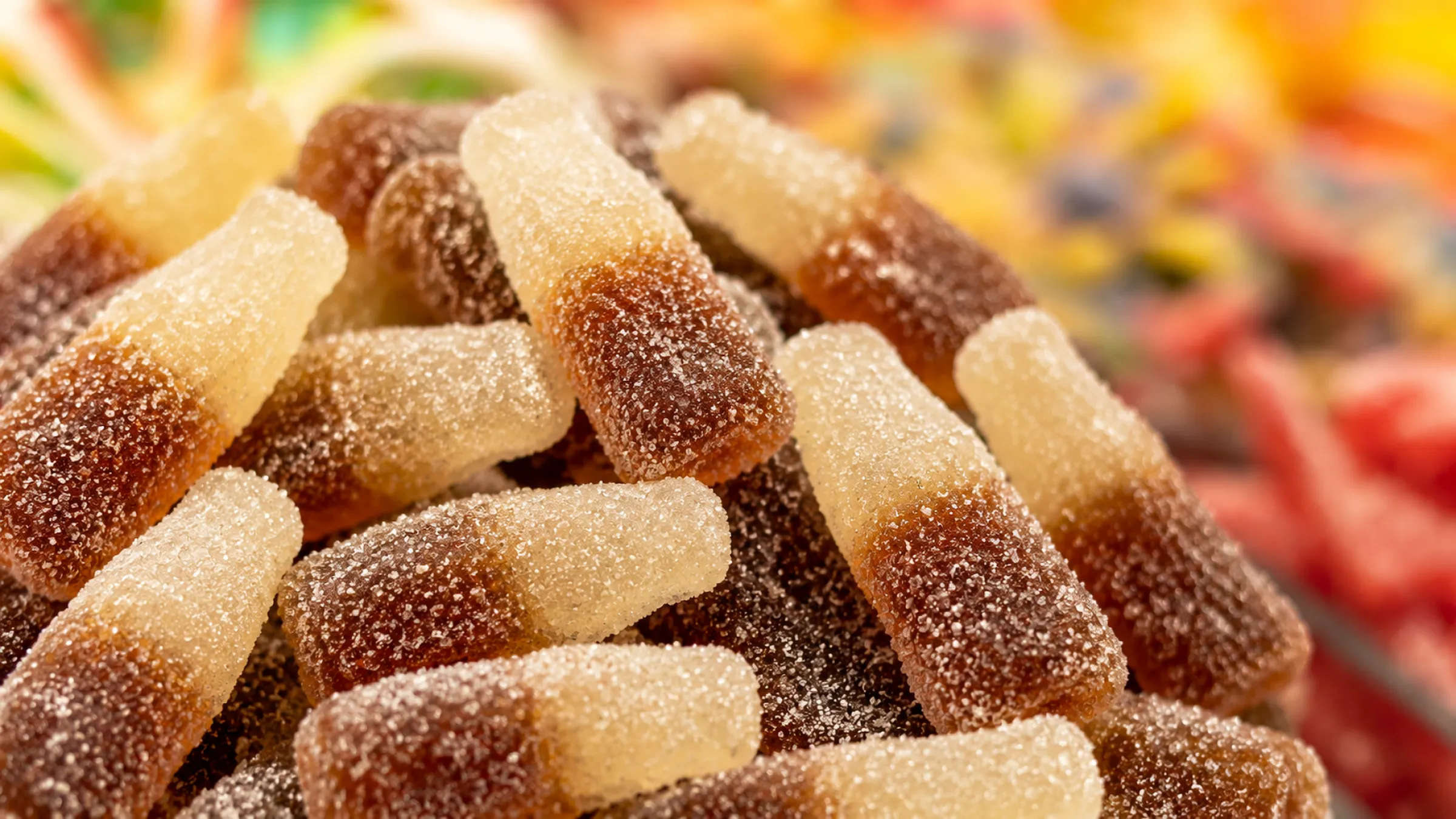 2.Cola bottle gummies in oiled, sour-sanded and crunchy sugar-coated finishes side by side