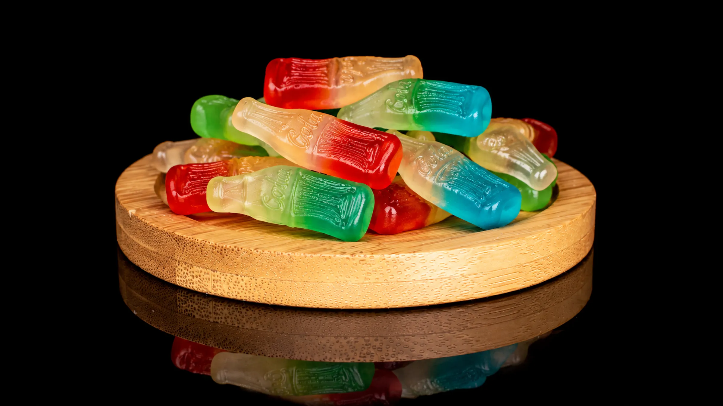 3.Cola bottle gummies in mini, standard and giant sizes side by side