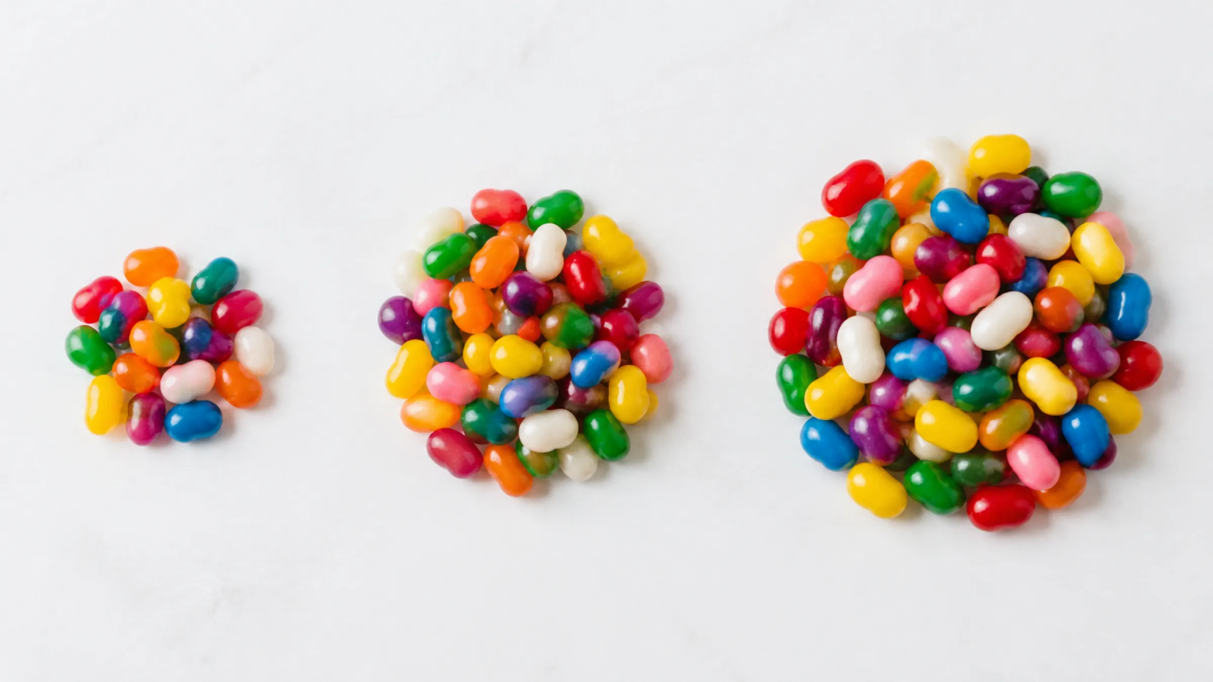 2.Three piles of candy beans in small, medium and large sizes side by side